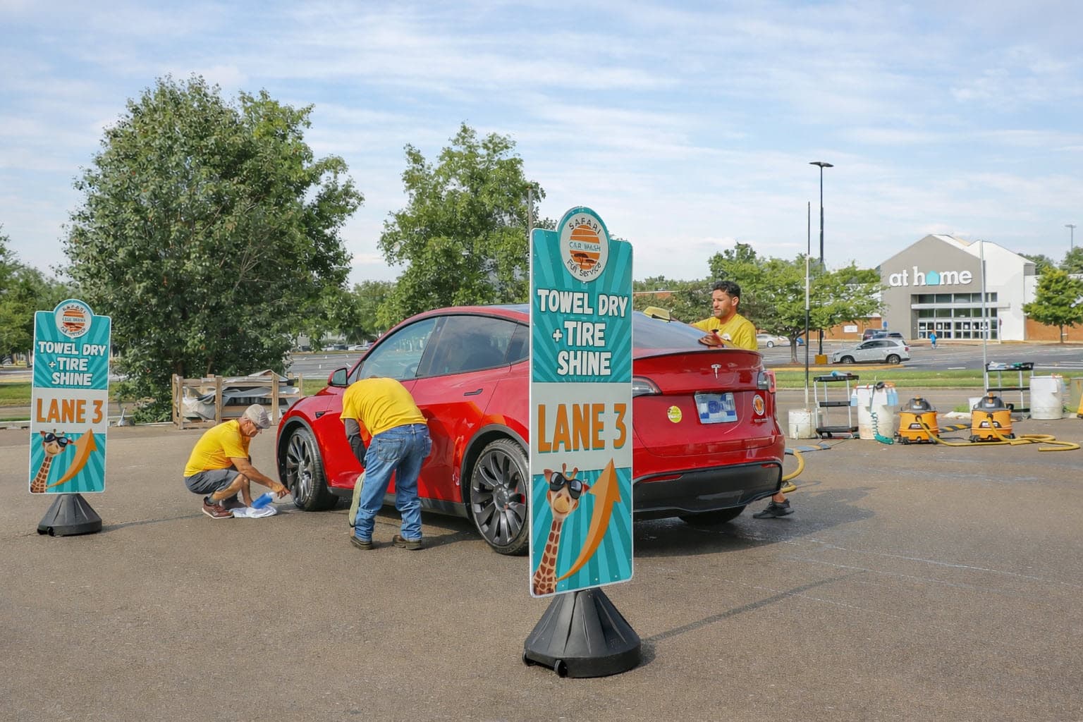Team member hand-drying vehicle at Safari Car Wash Franklin